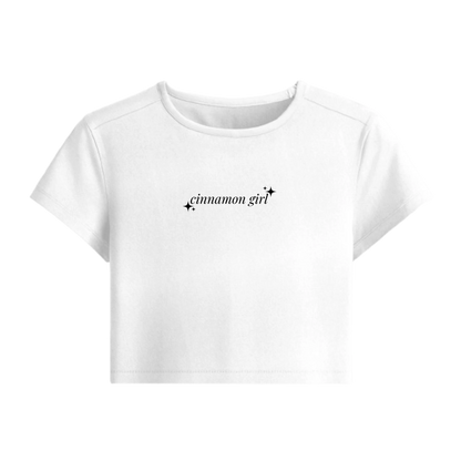 White crop top with 'cinnamon girl' text on a white background