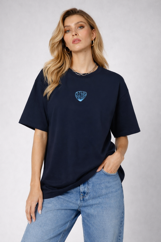 Woman wearing a navy blue t-shirt with a logo on a light gray background